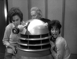 Barbara, the Doctor and Susan attempt to extricate Ian from inside the Dalek.