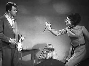 Susan threatens Ian with a pair of scissors.