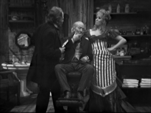 The Doctor in Doc Holliday's dentist chair.  Beside the Doctor is Kate, Doc's girlfriend