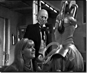 The Tenth Planet introduces the Cybermen to Doctor Who for the first time.  A Cyberman is pictured here with Polly and the Doctor