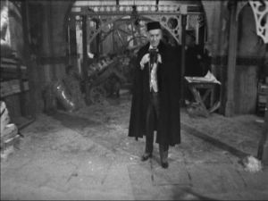 The Doctor, in that amazing cape, stares down the War Machine in the episode 3 cliff hanger