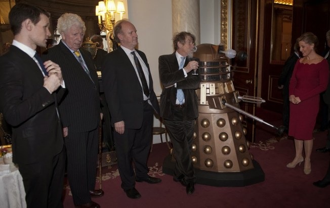 John Hurt leans nonchalantly against a Dalek.  What a classic image!